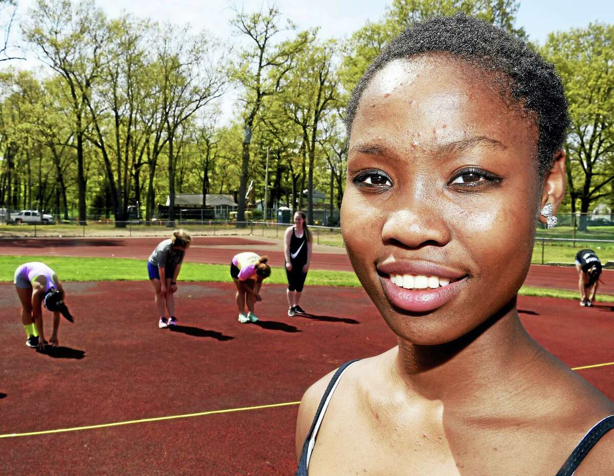 Erica, a 15-year-old North Haven High School student who is looking for a family to adopt her, with her high school track team Thursday, May 12, 2016.