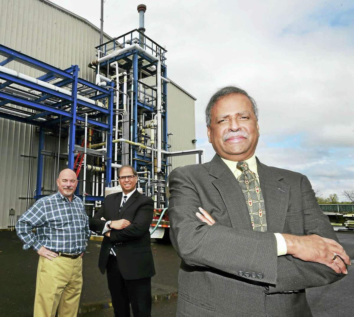N. C. Murthy, President and CEO of New Haven Chlor-Alkali, doing business as H. Krevit & Company, right, with Bruce H. Wilson Jr. senior vice-president of operations, left, and Thomas Ross, senior vice-president of sales, center, stand by a hydrochloric acid synthesis unit at the 97-year-old New Haven based company, Friday, May 6, 2016. New Haven Chlor-Alkali, as H. Krevit & Company, manufactures sodium hypochlorite (bleach), caustic soda and hydrochloric acid from salt to be used a water treatment chemicals.