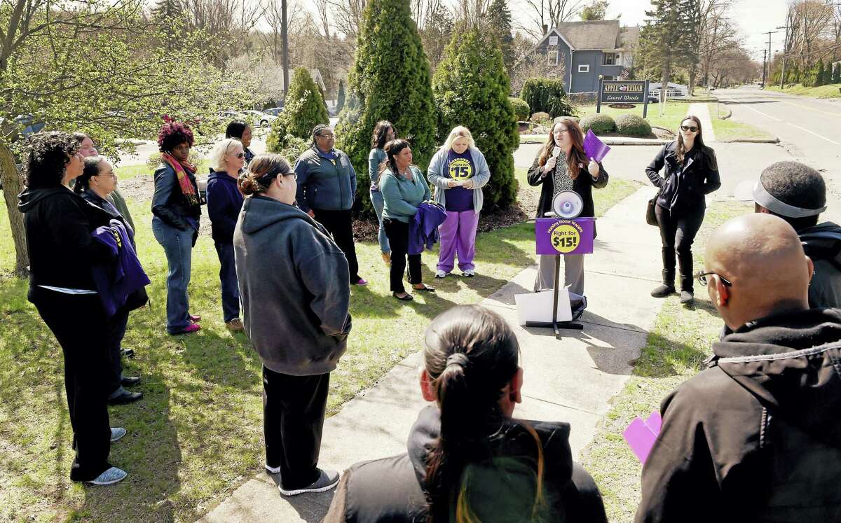Suzanne Clark, vice president of the New England Health Care Employees Union SEIU Local 1199 of Hartford, speaks to union workers as they rally for higher wages Thursday in front of Apple Rehab Laurel Woods in East Haven, a non-union short-term rehabilitation facility.