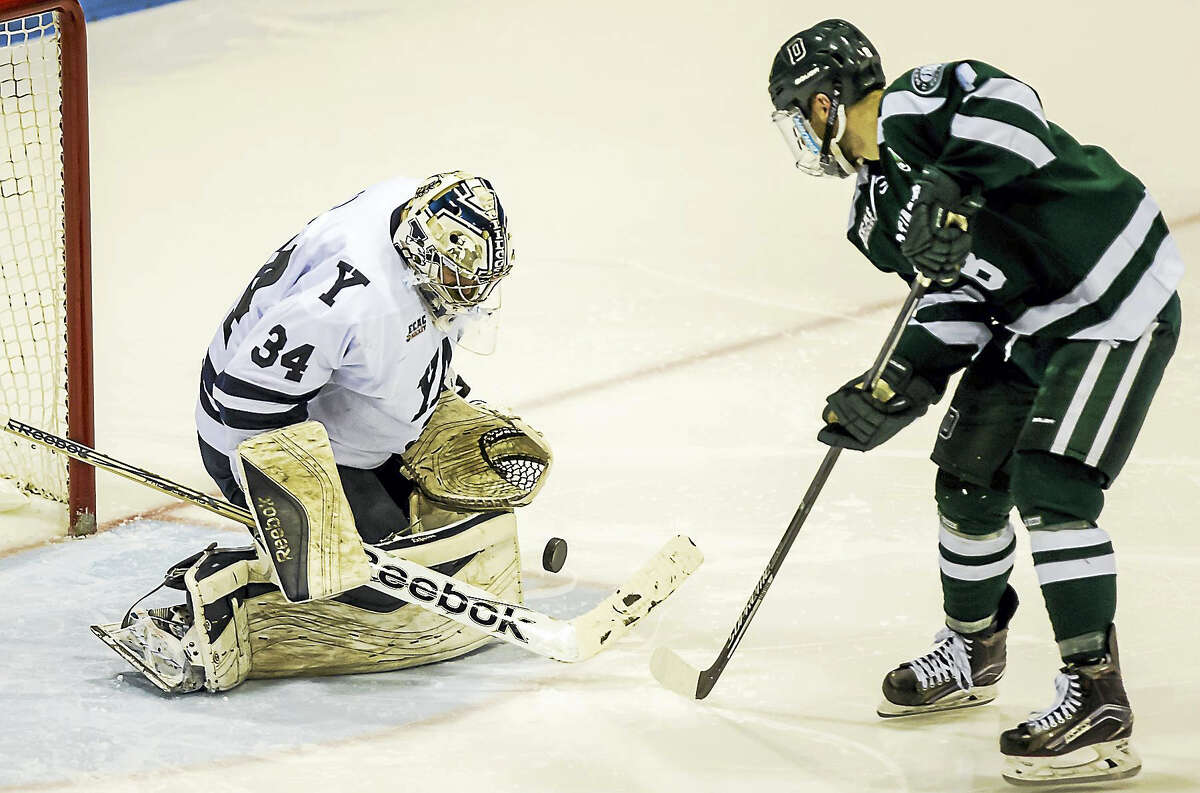 Yale goaltender Alex Lyon makes a breakaway save off the shot of Dartmouth's Tim O'Brien during Yale's Quaterfinal opening game at Ingall's Friday evening.-John Vanacore/Register