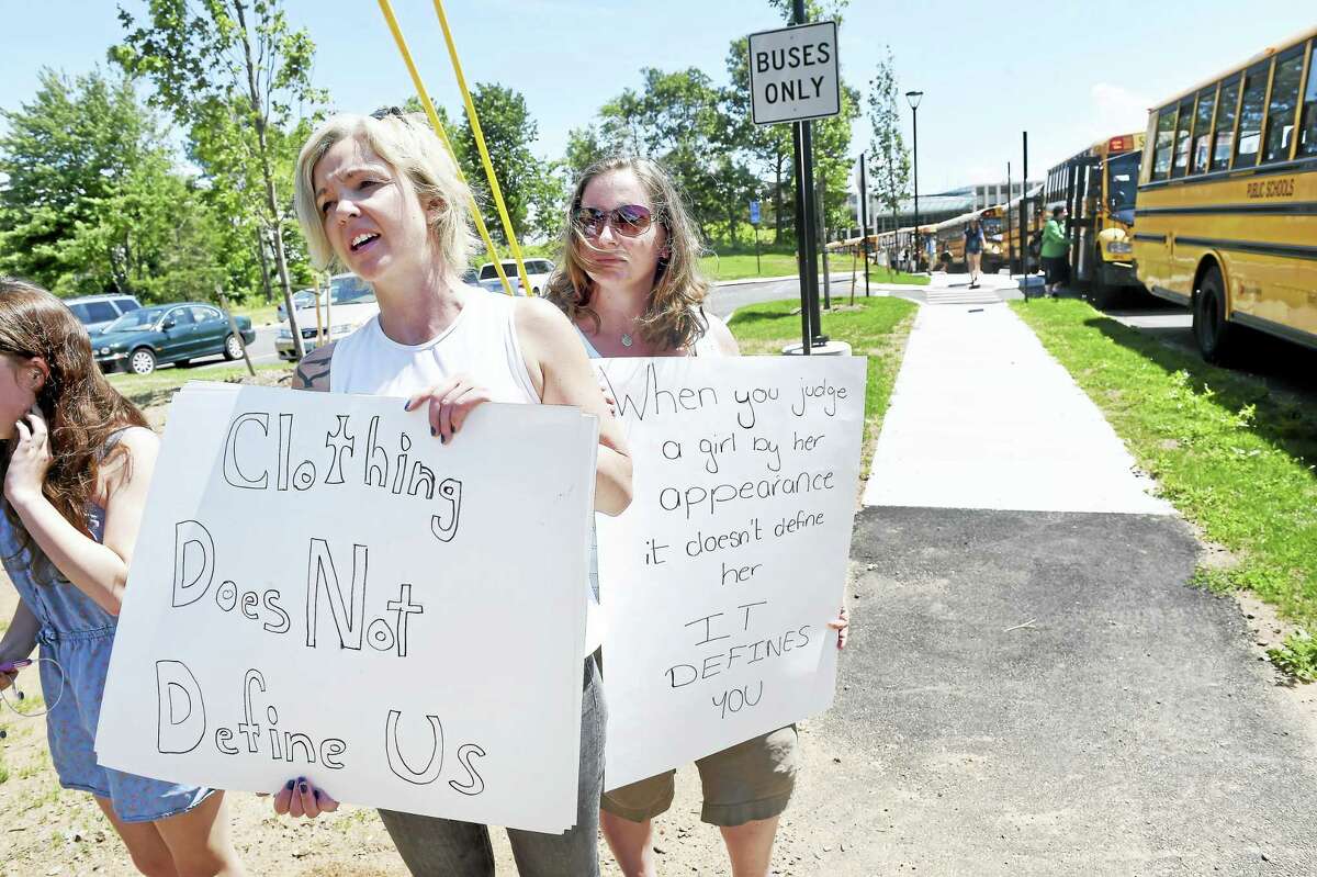 Samantha Parsons, left, and Jennifer Benben, center, of Guilford protest the school dress code and what they say is unfair enforcement at Guilford High School Tuesday.
