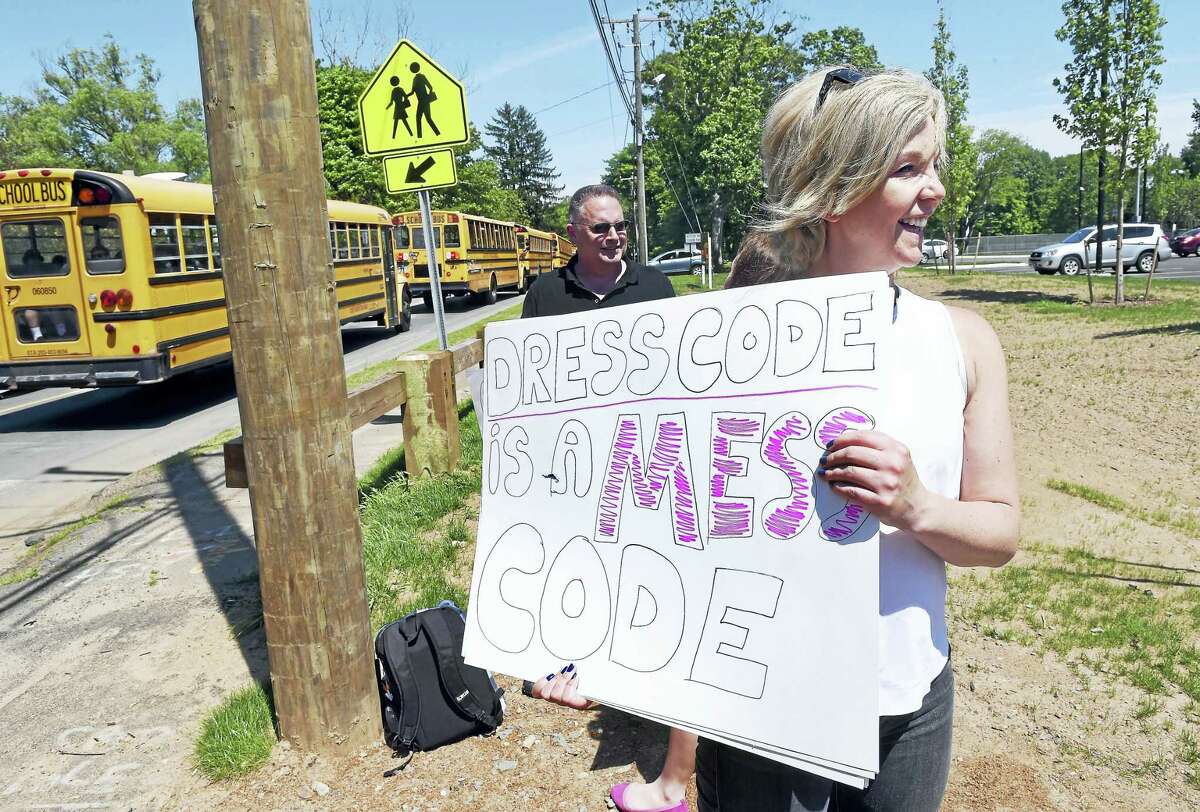 Arnold Gold — New Haven Register Samantha Parsons, front, and Kirby Hawkes of Guilford protest the dress code Tuesday.