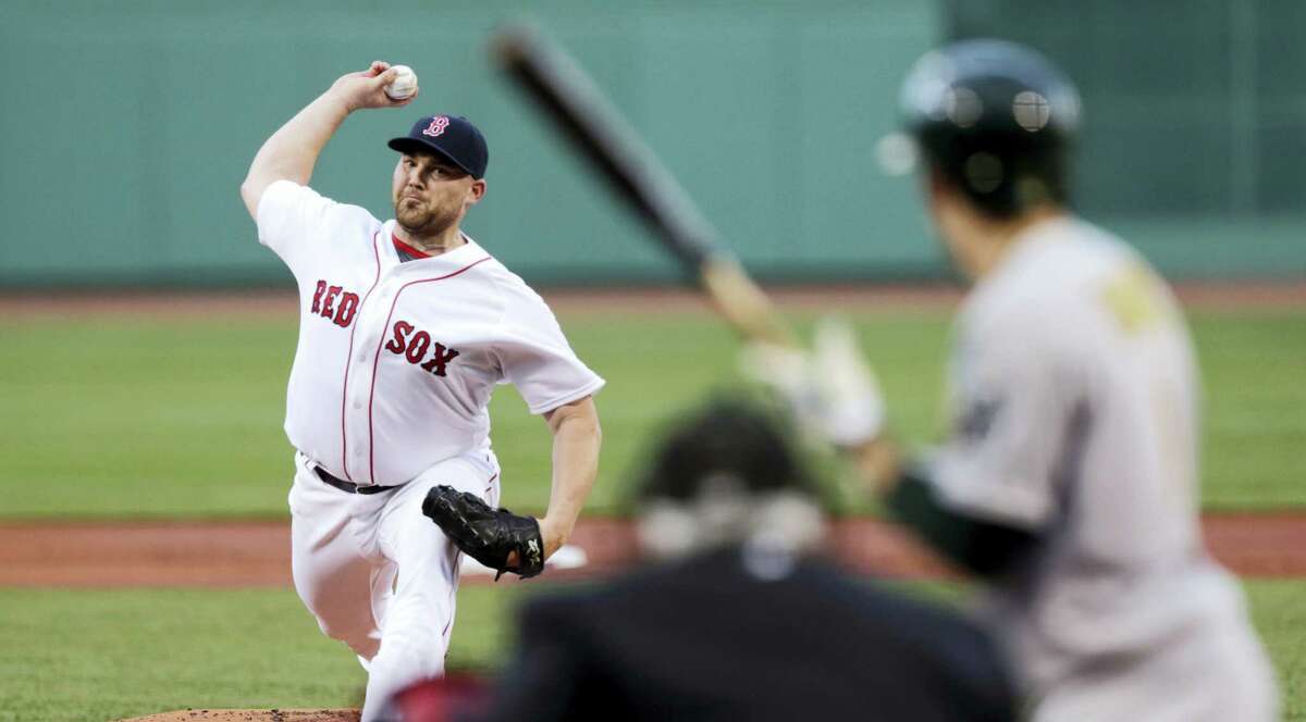CHARLES KRUPA — THE ASSOCIATED PRESS Boston Red Sox starting pitcher Sean O’Sullivan delivers during the first inning of the Red Sox’ 13-5 win over the Oakland Athletics Tuesday.