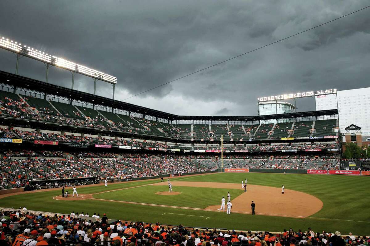 Storm clouds roll over Oriole Park at Camden Yards in the eighth inning on Sunday.