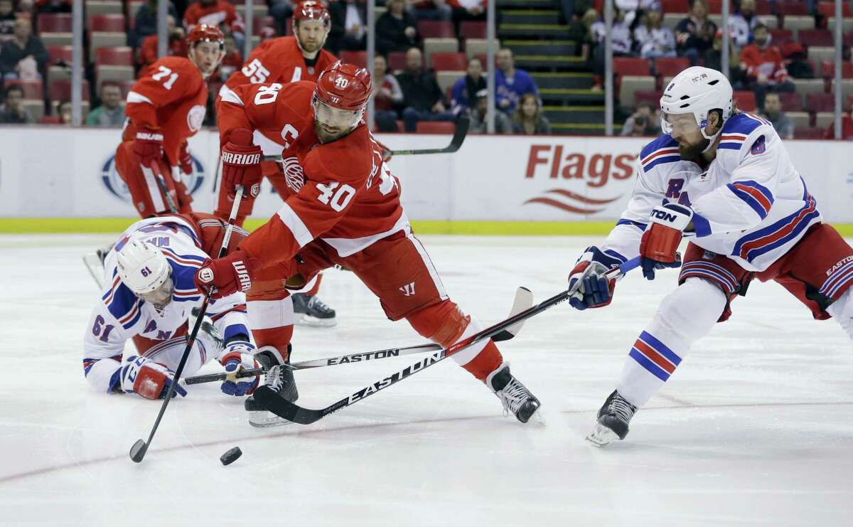 Red Wings left wing Henrik Zetterberg (40) controls the puck in front of Rangers defenseman Kevin Klein during the first period on Saturday.