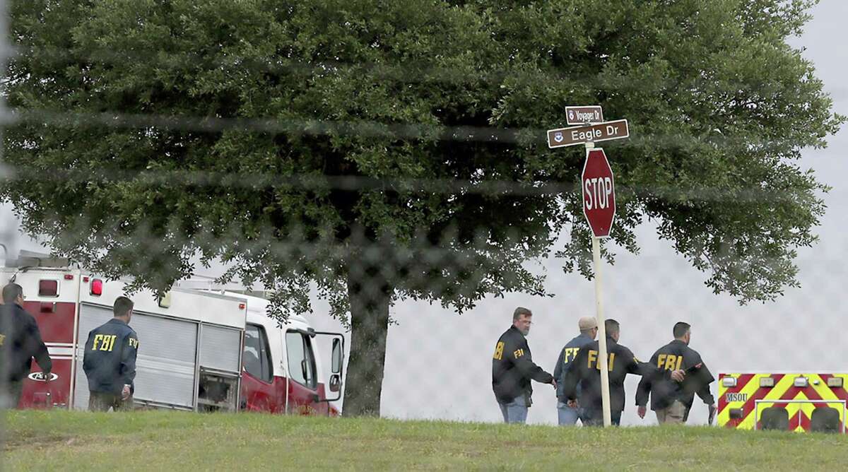 First responders and FBI agents gather near the scene of a shooting at Joint Base San Antonio-Lackland, Friday, April 8, 2016, in San Antonio.