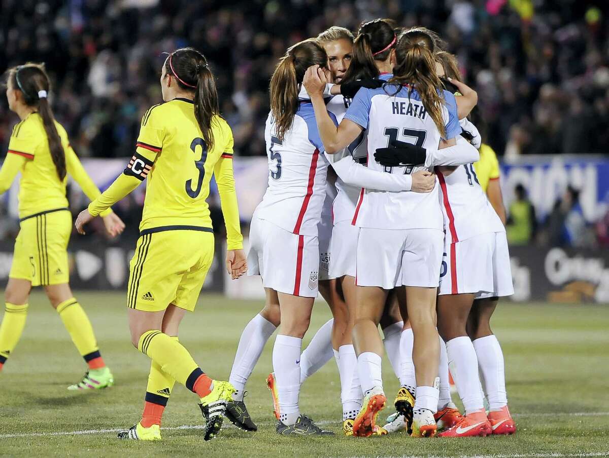 The United States women's team celebrate a goal by United States’ Crystal Dunn during the first half of an international friendly soccer match against Colombia at Pratt & Whitney Stadium at Rentschler Field, Wednesday, April 6, 2016, in East Hartford, Conn. The U.S. won 7-0. (AP Photo/Jessica Hill)