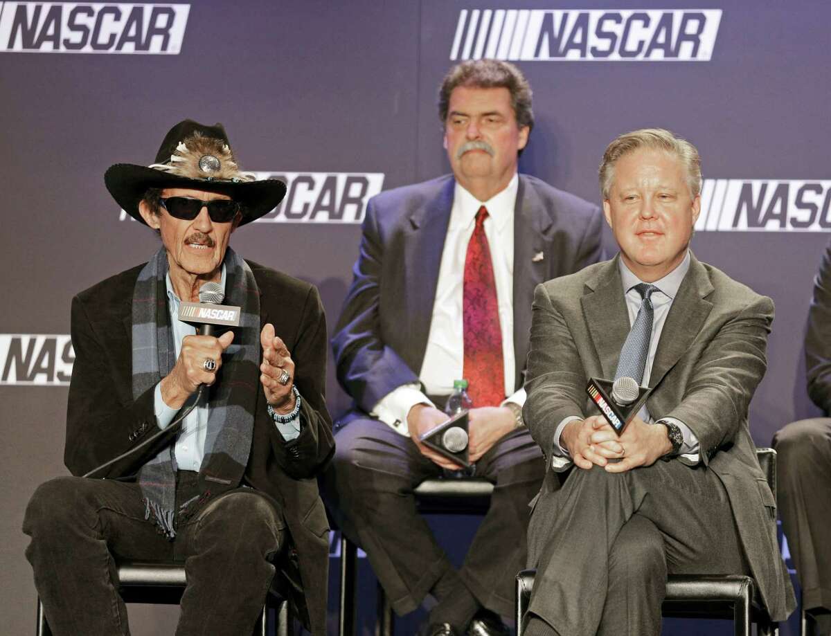 Team owner Richard Petty, left, speaks as NASCAR Chairman and CEO Brian France, right, and NASCAR president Mike Helton, back, listens during a news conference on Tuesday.