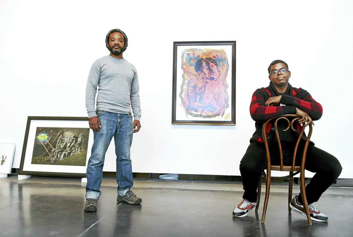 Co-curators William Villalongo, left, and Mark Thomas Gibson during the hanging of a new exhibition “Black Pulp!” Wednesday January 13, 2016 at the Yale School of Art’s 32 Edgewood Gallery in New Haven that explores the creative use of printed media and artwork to challenge racist narratives and change limited notions of the black experience in America. “Black Pulp!” features 65 objects, including rare magazines, literary novels, cartoons, and comics, as well as contemporary art from the Black Diaspora. It tells a story of black and non-black artists and publishers working together over 90 years to draw attention to the black experience.