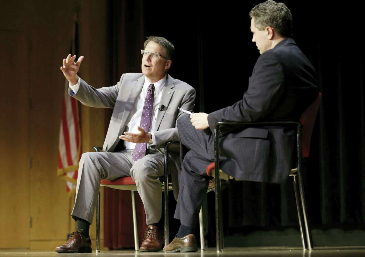 North Carolina Gov. Pat McCrory, left, makes remarks regarding House Bill 2 while speaking during a government affairs conference in Raleigh, N.C., Wednesday, May 4, 2016. A North Carolina law limiting protections to LGBT people violates federal civil rights laws and can’t be enforced, the U.S. Justice Department said Wednesday, putting the state on notice that it is in danger of being sued and losing hundreds of millions of dollars in federal funding.
