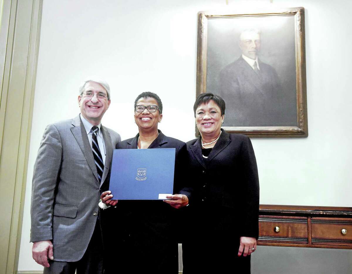 Elsie Chapman, center, is honored with an Elm Award by Yale University President Peter Salovey and New Haven Mayor Toni Harp at the Seton Elm-Ivy Awards at Yale’s Woolsey Hall in New Haven Tuesday.