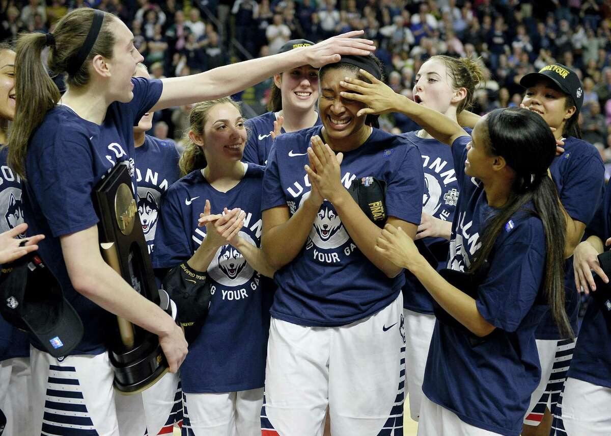 Connecticut’s Breanna Stewart, left, and Moriah Jefferson, right, celebrate with Morgan Tuck, center, after winning 86-65 over Texas in a college basketball game in the regional final of the women's NCAA Tournament, Monday, March 28, 2016, in Bridgeport, Conn. (AP Photo/Jessica Hill)
