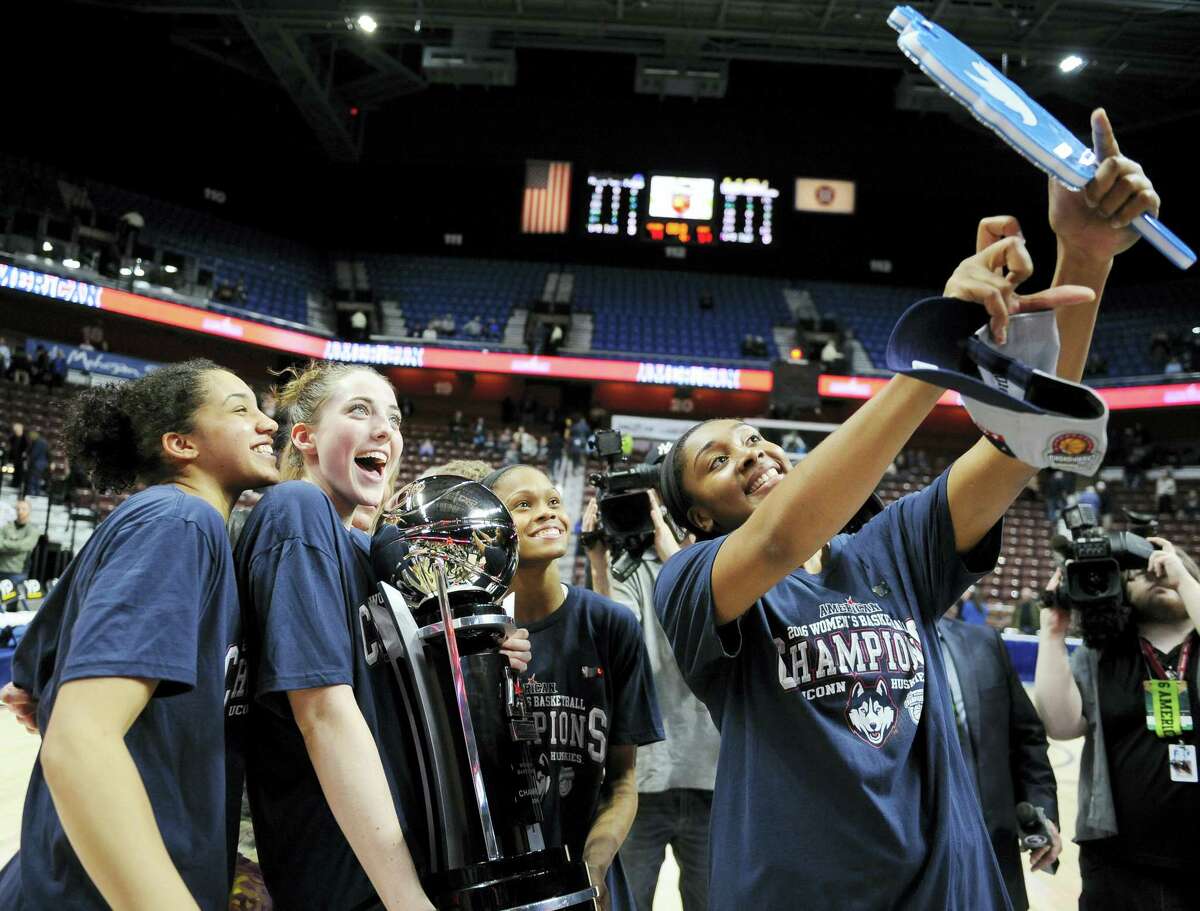 UConn’s Morgan Tuck, right, holds up a camera for players Gabby Williams, left, Katie Lou Samuelson, second from left, and Moriah Jefferson after Monday’s win.