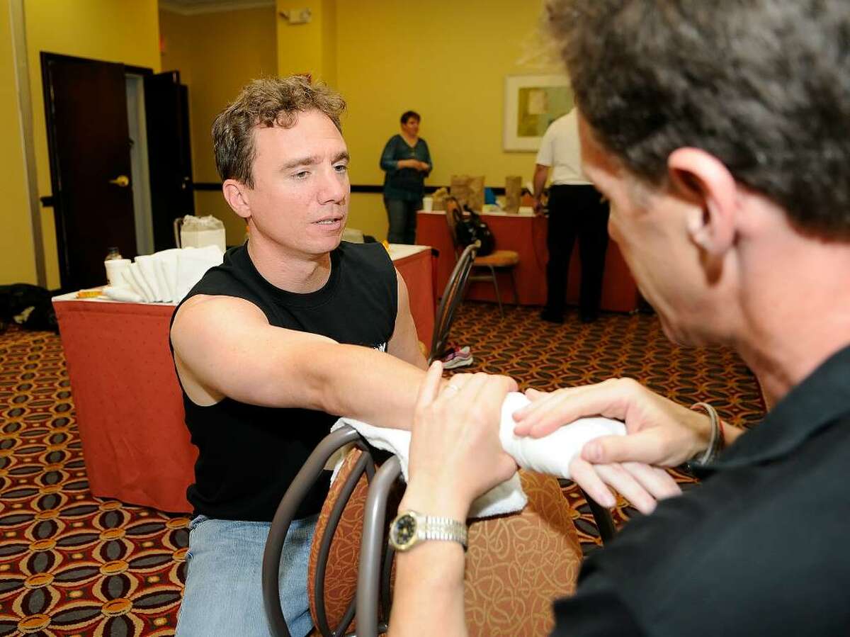 Trainer Colin Albert, Bridgewater, tapes the hands of Ryan Clifford, Stamford, before his boxing match. By day, Clifford is a trader for Energy Trading Company. The amateur boxer is part of a charity event called the "Real Fight Club Stamford," hosted by the Revolution Fitness Youth Foundation of Stamford at the Stamford Holiday Inn on Friday June 11, 2010. Proceeds will benefit Hope for Haiti, the Revolution Fitness Youth Foundation and the local chapter of USA Boxing. A three-course dinner is also part of the $100-per-ticket event.
