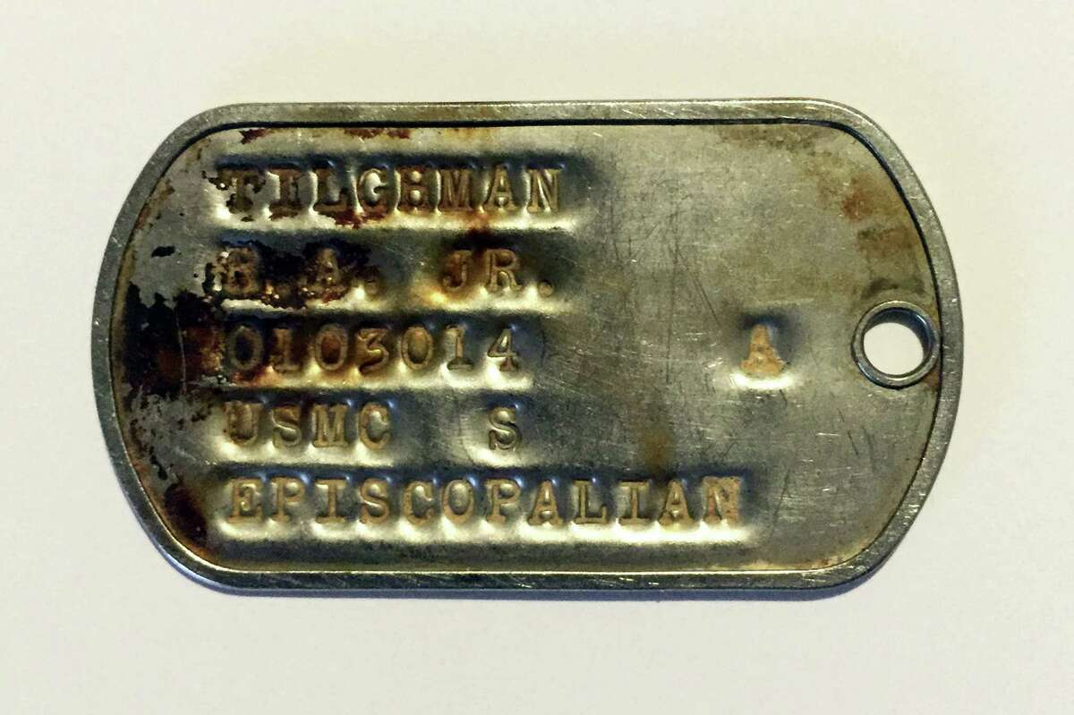 This 2015 photo provided by BNY Mellon shows a dog tag from the Vietnam War identifying U.S. Marine R. A. Tilghman, Jr. While vacationing in Vietnam in 2014, Briton Charles Thompson purchased the tag from a local vendor thinking he could find and return it to its owner. After more than a year of research, he located Richard Tilghman, of New Canaan, Conn.