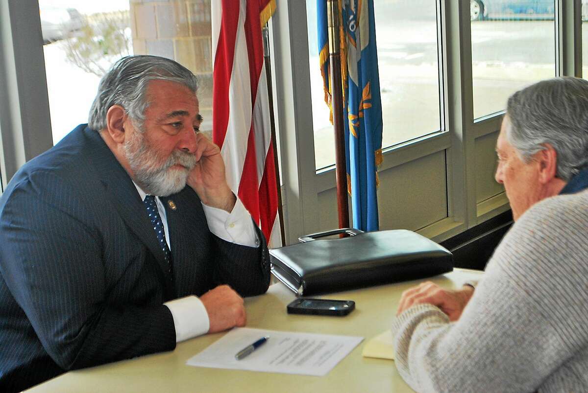 State Rep. Charles Ferraro, R-West Haven, talks one-on-one with a Milford resident during office hours at the Milford Library.