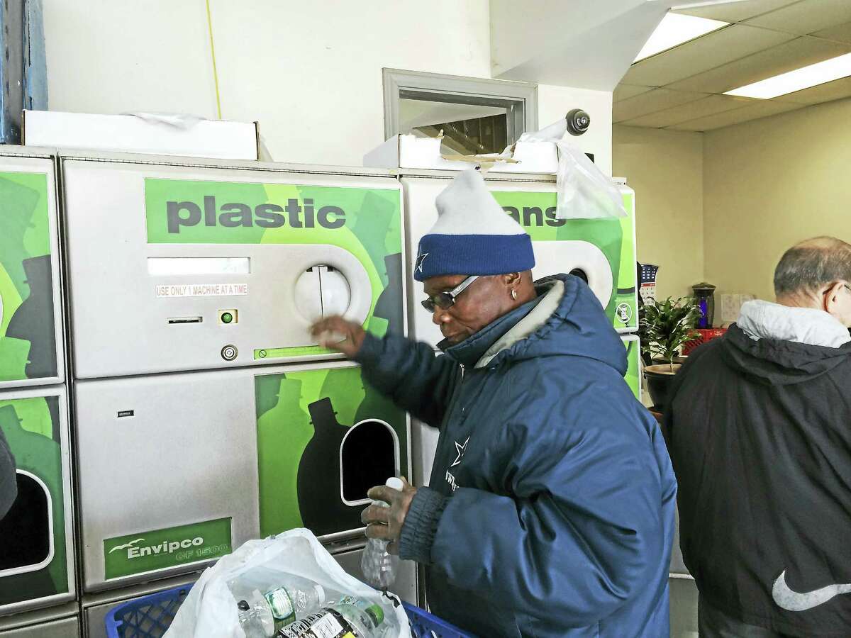 Abraham Robinson of Meriden recycles bottles Tuesday at the M&M Redemption Center in Wallingford.