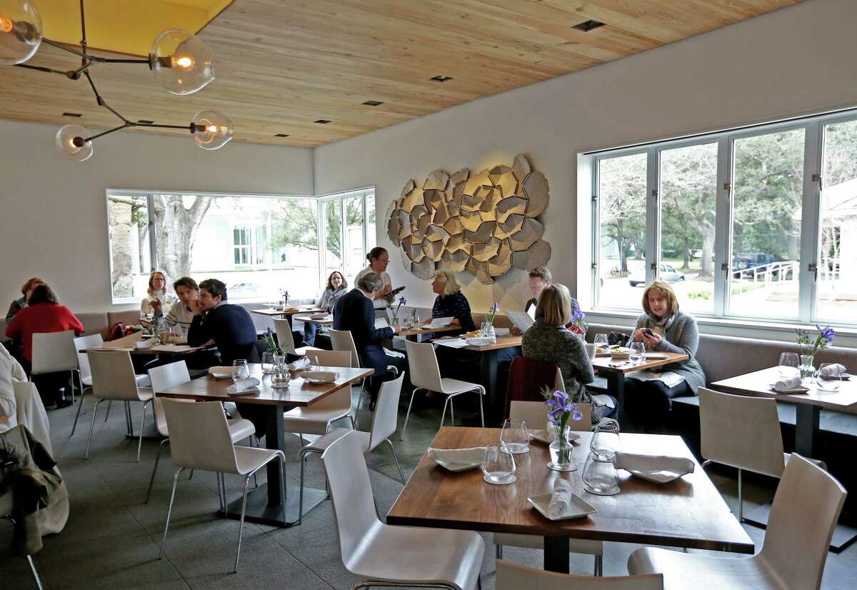 Above: Bistro Menil offers a lunch and dinner menu. ﻿Left: Chef Hugo Ortega's Xochi ﻿features ﻿foods of Oaxaca, Mexico, including Negro en Negro, a dish that features ﻿black-footed chicken, mole negro and creamy corn meloso.﻿