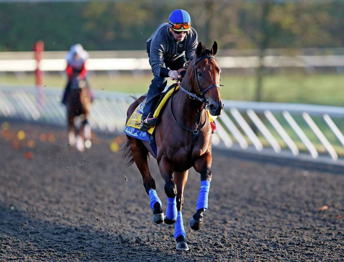 Triple Crown winner American Pharoah is ridden by exercise rider Jorge Alvarez during a workout for the Breeders’ Cup Classic Thursday at Keeneland race track in Lexington, Ky.