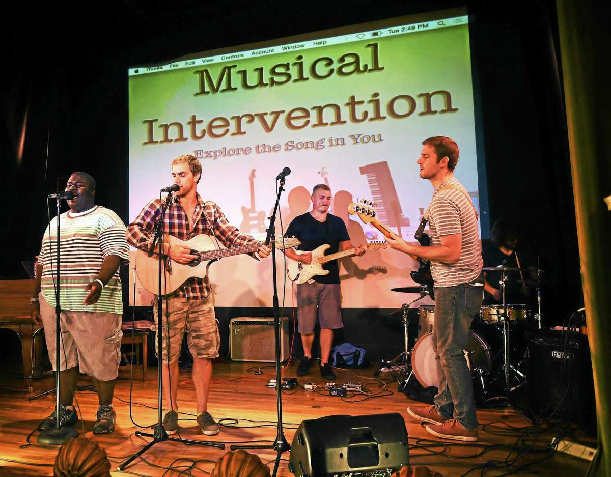 Singer, guitarist and pianist Jeremiah Brown of New Haven, 16, left; songwriter, guitarist and founder of Musical Intervention Adam Christoferson of Hamden, 31; guitarist Ryan Tracey; leader of the Low Hanging Fruit band bass guitarist Stephen Healy of Clinton, 29; and drummer Brendan Galvin of Guilford, 29, during a rehearsal at Lyric Hall on Whalley Avenue in New Haven Tuesday afternoon, July 28, 2015.