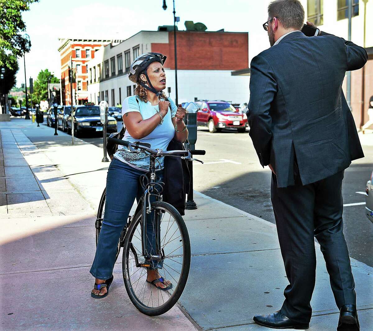 Doug Hausladen, the Director of Transportation, Traffic & Parking talks to a bicyclist who still prefers sidewalks over the bike path in New Haven, Wednesday August 26, 2015.