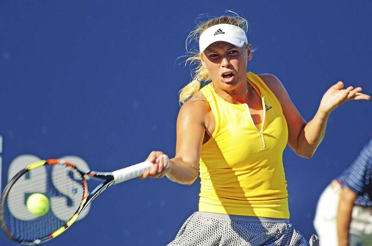 Caroline Wozniacki survived a third-set tiebreaker against Italian qualifier Roberta Vinci on Wednesday to advance to the quarterfinals of the Connecticut Open.