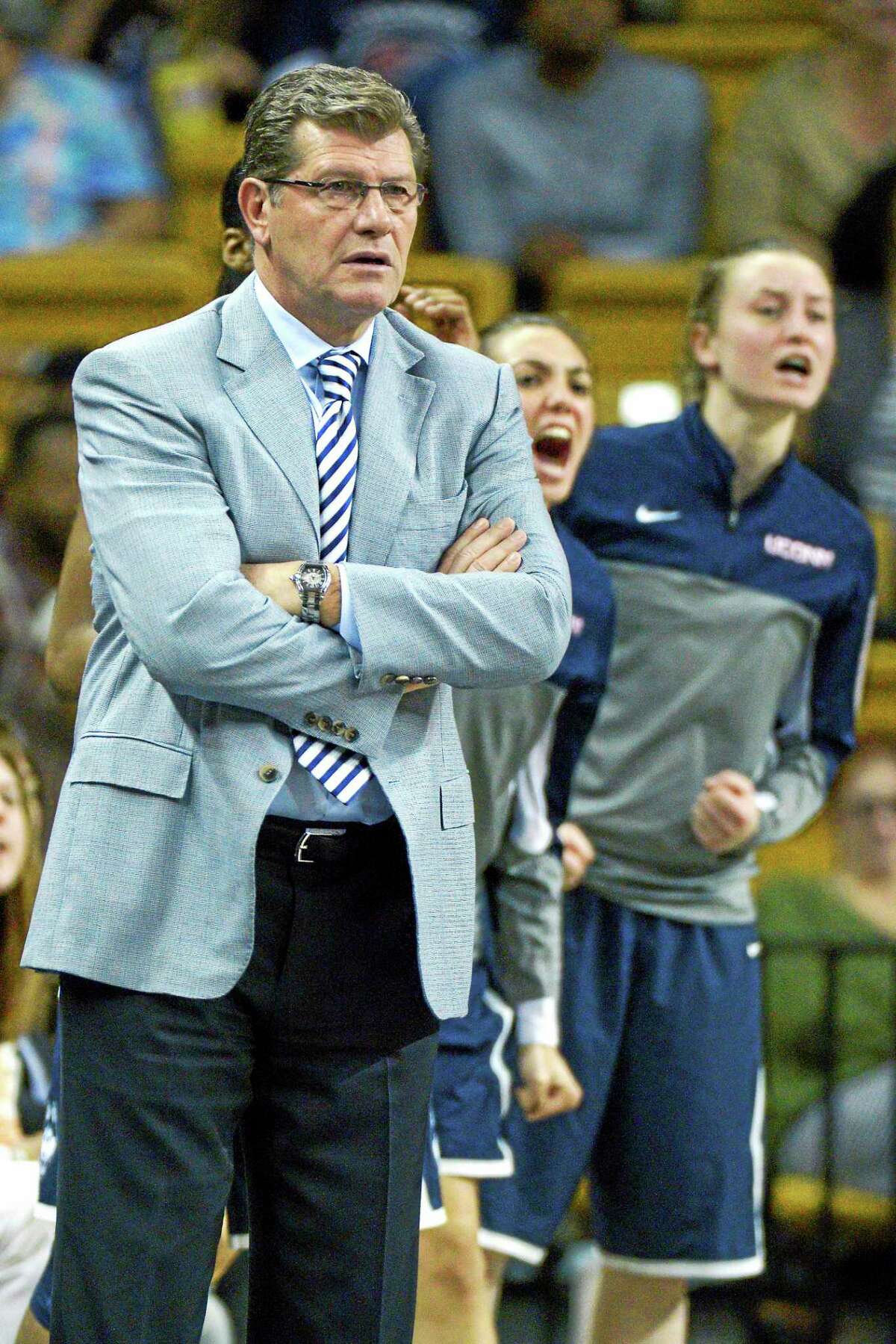 UConn coach Geno Auriemma, left, has awarded scholarships to walk-ons Briana Pulido, center, and Ansonia’s Tierney Lawlor, right.