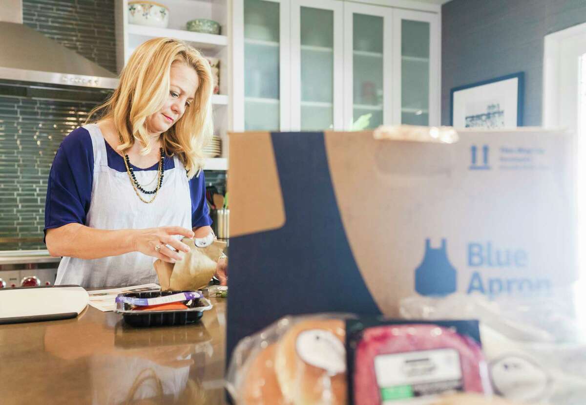 FILE Â?— Jennifer Freed opens a Blue Apron meal kit at home in Los Angeles, March 25, 2016. On the eve of Blue ApronÂ?’s initial public offering, the meal delivery service repriced its shares downward to a target of $10 to $11 each on June 28, 2017, reflecting investor wariness over its profitability and vulnerability to competition. (Oriana Koren/The New York Times)