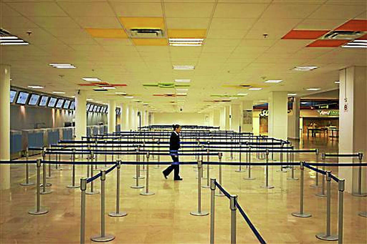 An airline employee walks in the empty airport where all flights are canceled as Hurricane Patricia approaches the Pacific resort city of Puerto Vallarta, Mexico, Friday. Oct. 23, 2015. Patricia headed toward southwestern Mexico Friday as a monster Category 5 storm, the strongest ever in the Western Hemisphere that forecasters said could make a “potentially catastrophic landfall” later in the day.