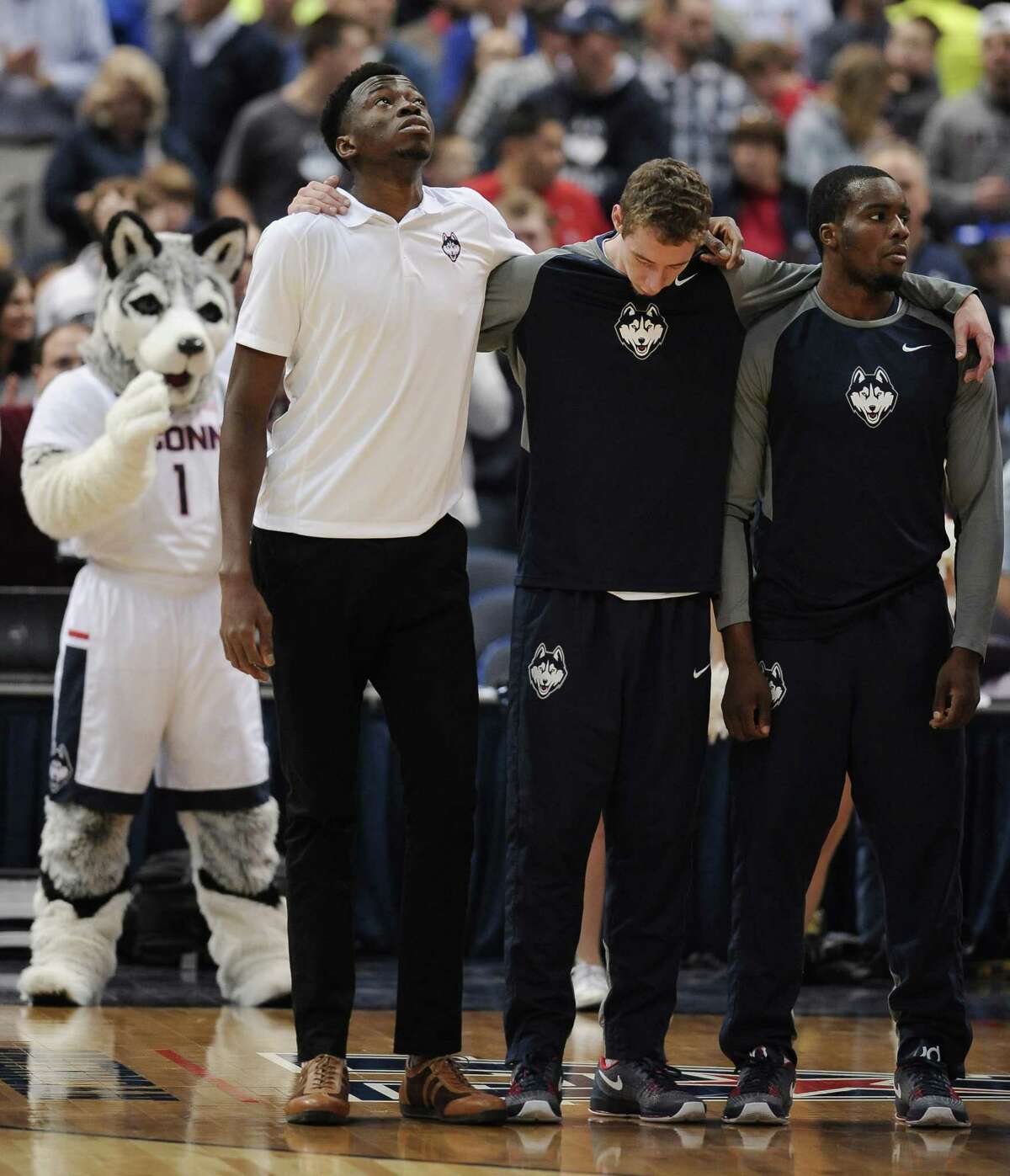 UConn’s Amida Brimah, left, looks up during the playing of the national anthem before Sunday’s game in Hartford.