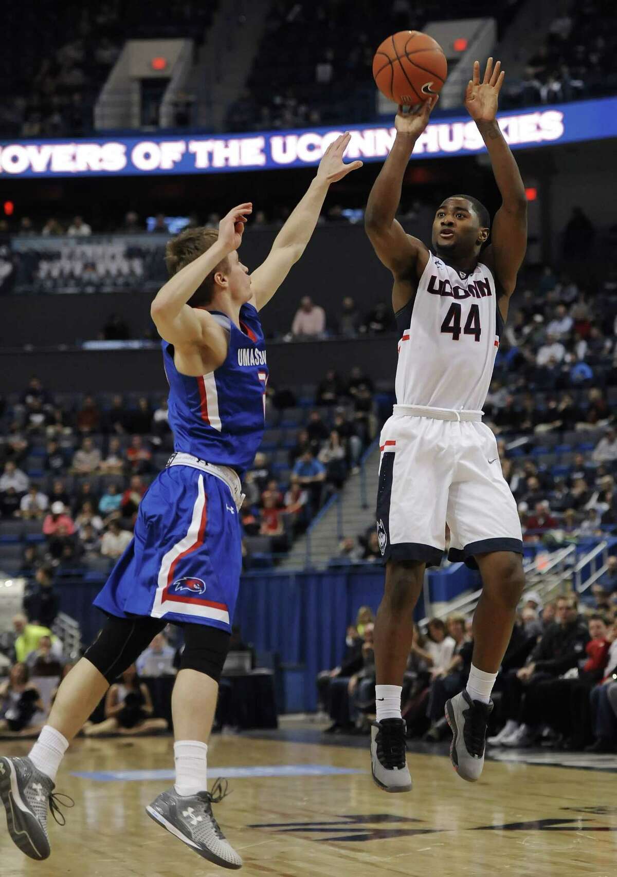 UConn’s Rodney Purvis, right, shoots over UMass-Lowell’s DJ Mlachnik, left, in the second half of Sunday’s game in Hartford.