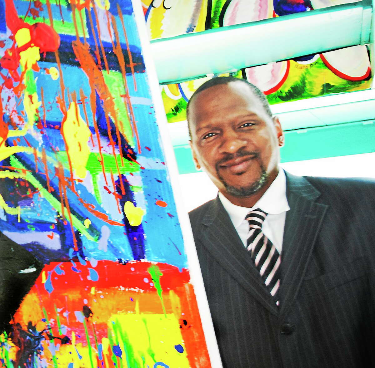 Hamden High School Principal Gary Highsmith in May 2014, next to a portion of a piece by senior Alicia Pascale in a student art show.