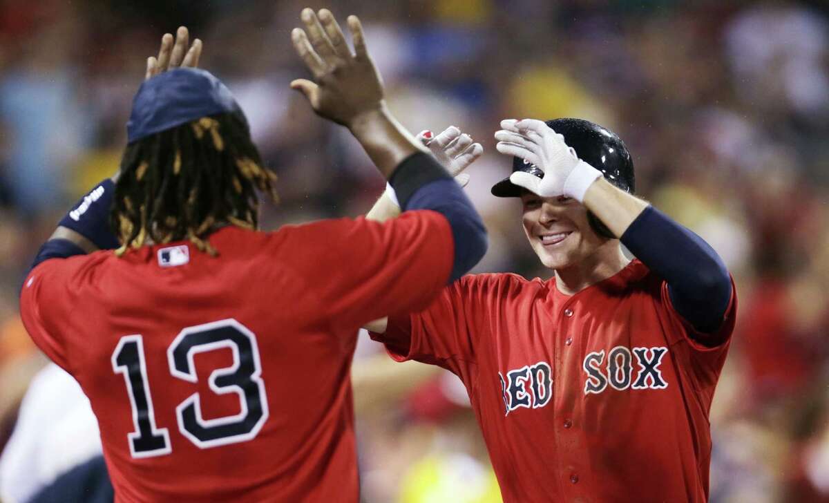 Boston Red Sox’s Josh Rutledge, right, is congratulated by Hanley Ramirez after his two-run home run against the Kansas City Royals.