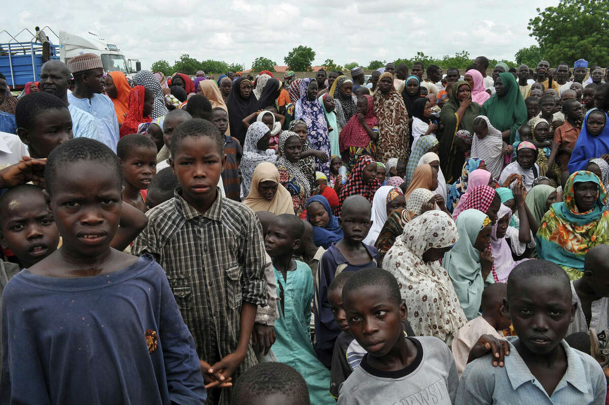 In this Sept. 9, 2014 photo, civilians who fled their homes following an attack by Islamist militants in Bama, take refuge at a school in Maiduguri, Nigeria.