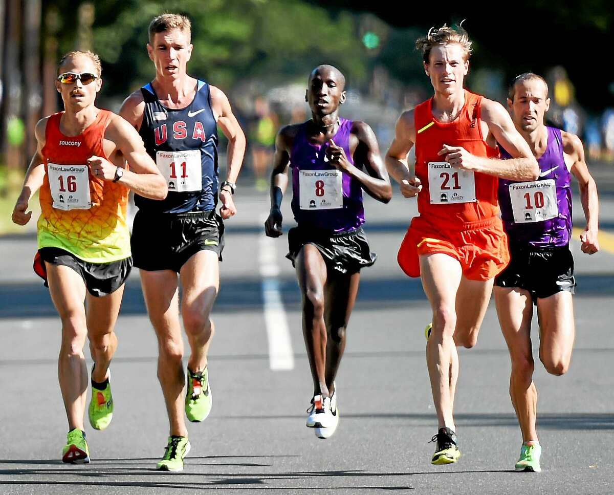 (Peter Hvizdak - New Haven Register) ¬ First place finisher Jared Ward of the U.S.A., left, runs down the home stretch of Whitney Ave in a close race against (second from left to right) fourth place finisher Luke Puskedra, second place finisher Sam Chelanga, fifth place finisher Tyler Pennel, and third place finisher Dathan Ritzenhein, en route to winning the 2015 New Haven Road Race Men's 20K and the 20K Men's National Championship in New Haven, Connecticut Monday, September 7, 2015 with a time of 59:24. 11 seconds separated the first five finishers.
