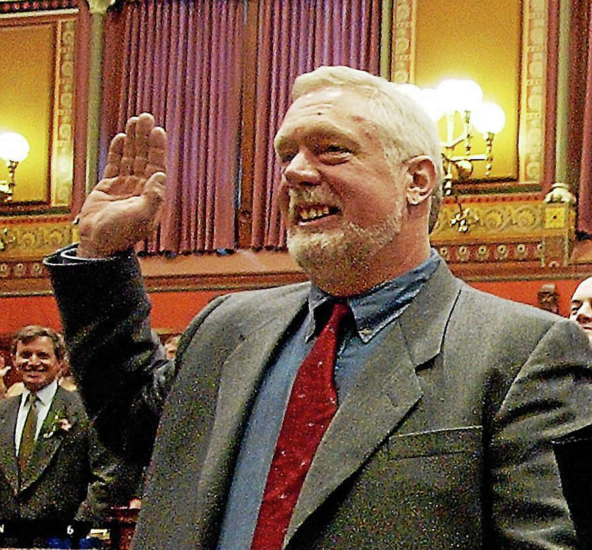 In this 2003 file photo, state Rep. Terry Backer, D-Stratford, takes the oath of office in the Hall of the House at the state Capitol in Hartford.