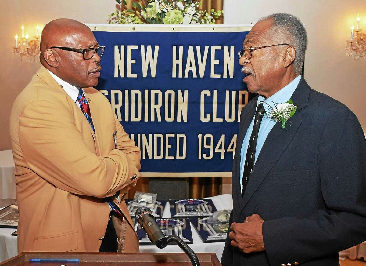 Floyd Little, left, greets Hillhouse teammate Bill McCoy, who was inducted into the New Haven Gridiron Club’s Hall of Fame.