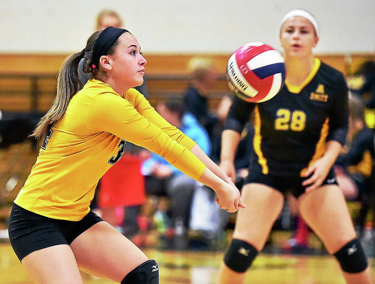 Amity’s Brooke Matyasovky (28) keeps her eye on the ball as her teammate Cassidy Kirby bumps a shot up to the net in Wednesday’s matchup against Hand.