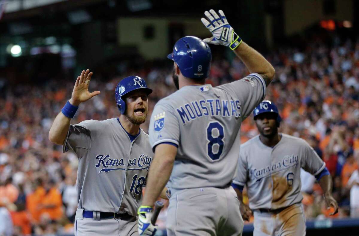 The Royals’ Ben Zobrist (18) celebrates with teammate Mike Moustakas (8) after he and Lorenzo Cain scored during a five-run rally in the eighth inning on Monday.
