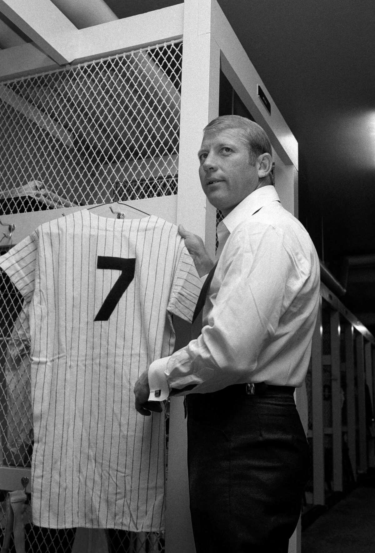 Mickey Mantle hangs up his uniform in the Yankee Stadium locker room on Mickey Mantle Day, June 8, 1969. The Yankees retired his number 7 on this day.