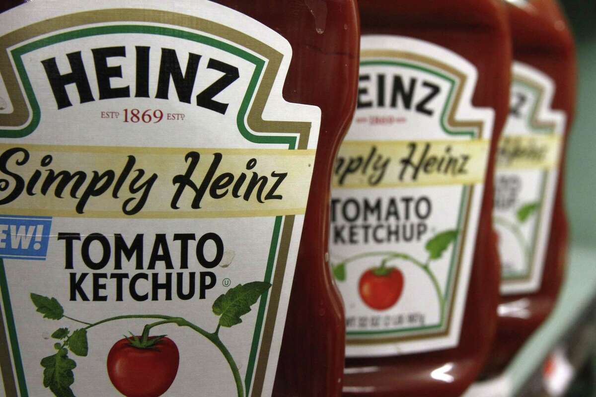 This March 2, 2011, file photo, shows containers of Heinz ketchup on the shelf of a market, in Barre, Vt. On Wednesday, Aug. 12, 2015, Kraft Heinz announced it was cutting about 2,500 jobs as part of its plan to slash costs after the food companies combined.