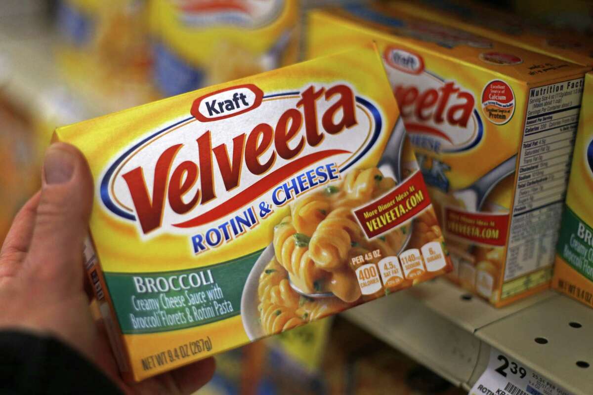This Tuesday, April 29, 2014, file photo, shows a display of Kraft Velveeta rotini and cheese at a grocery market in Pittsburgh. On Wednesday, Aug. 12, 2015, Kraft Heinz announced it was cutting about 2,500 jobs as part of its plan to slash costs after the food companies combined.