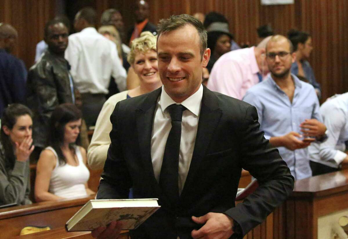 Oscar Pistorius leaves a courtroom of the High Court in Pretoria, South Africa, on Tuesday.
