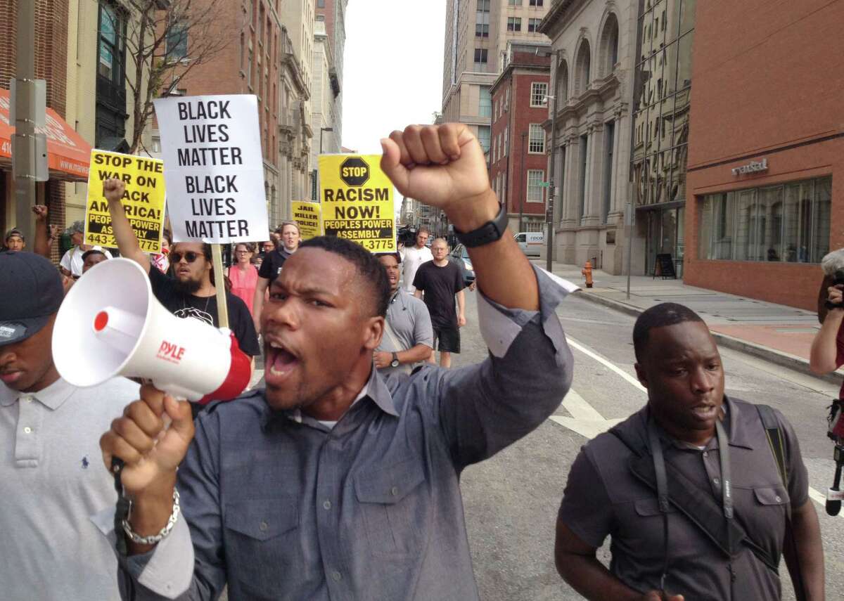 In a Wednesday, Sept. 2, 2015, file photo, Pastor Westley West, from Faith Empowered Ministries, leads protesters as they march towards Pratt Street and the Inner Harbor in Baltimore, as the first court hearing was set to begin for six police officers criminally charged in the death of Freddie Gray. West was arrested Wednesday, Sept. 9, a week after police say he blocked traffic while protesting during pre-trial hearings in the Freddie Gray case. He is charged with attempting to incite a riot, malicious destruction of property, disorderly conduct, disturbance of the peace, false imprisonment and failure to obey.