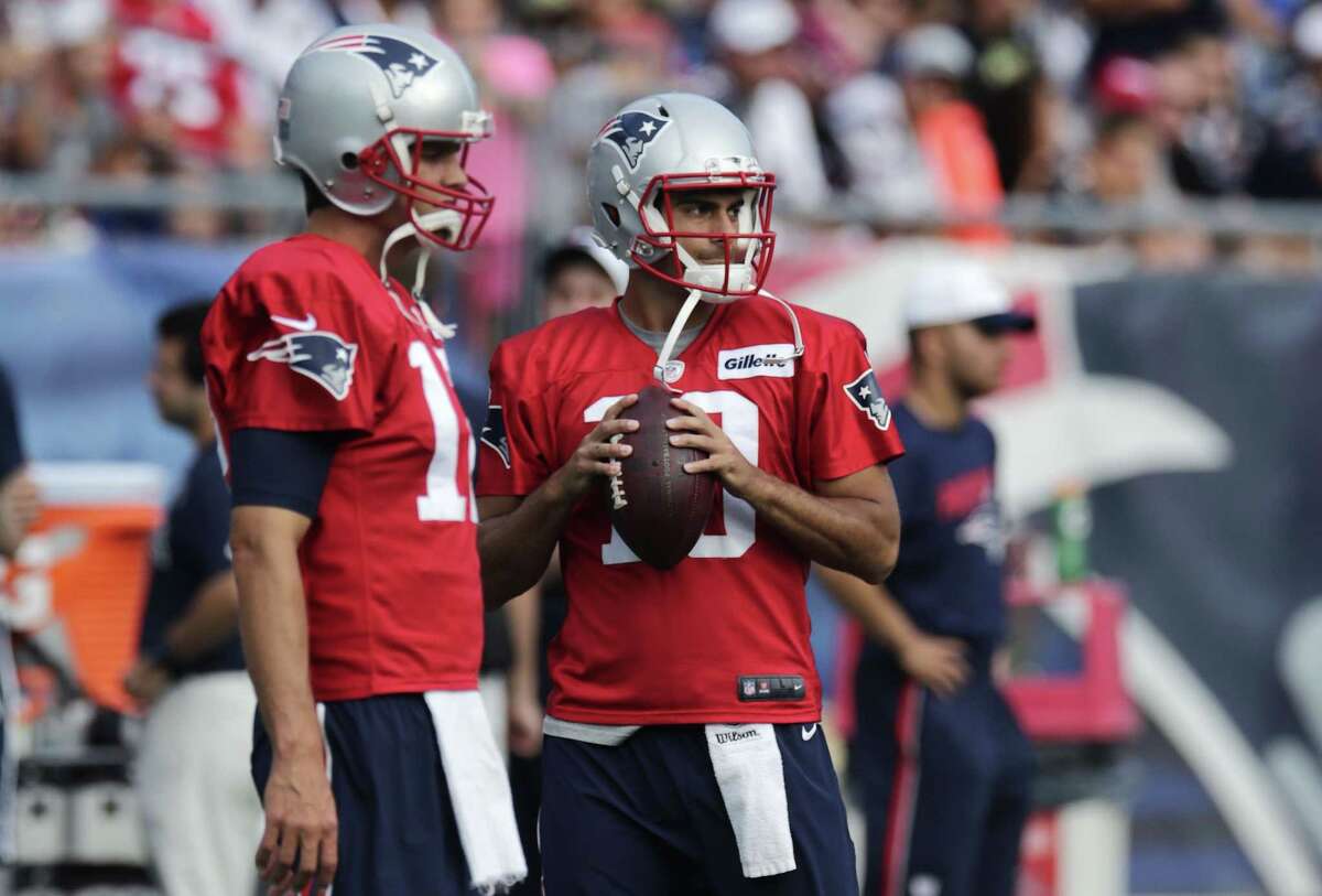 New England Patriots quarterback Jimmy Garoppolo, right, and Tom Brady participate in training camp on Wednesday in Foxborough, Mass.
