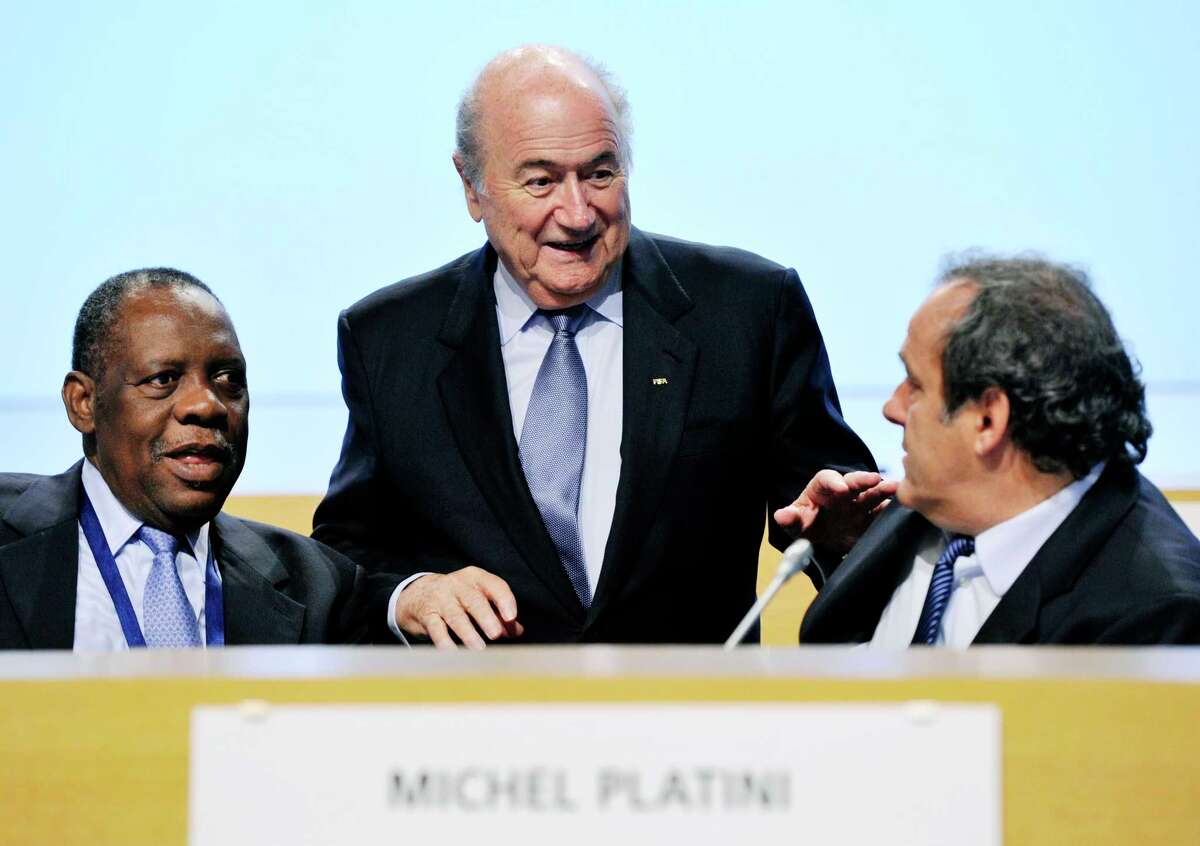 FIFA President Sepp Blatter, center, and UEFA President Michel Platini, right, have been banned for 90 days.