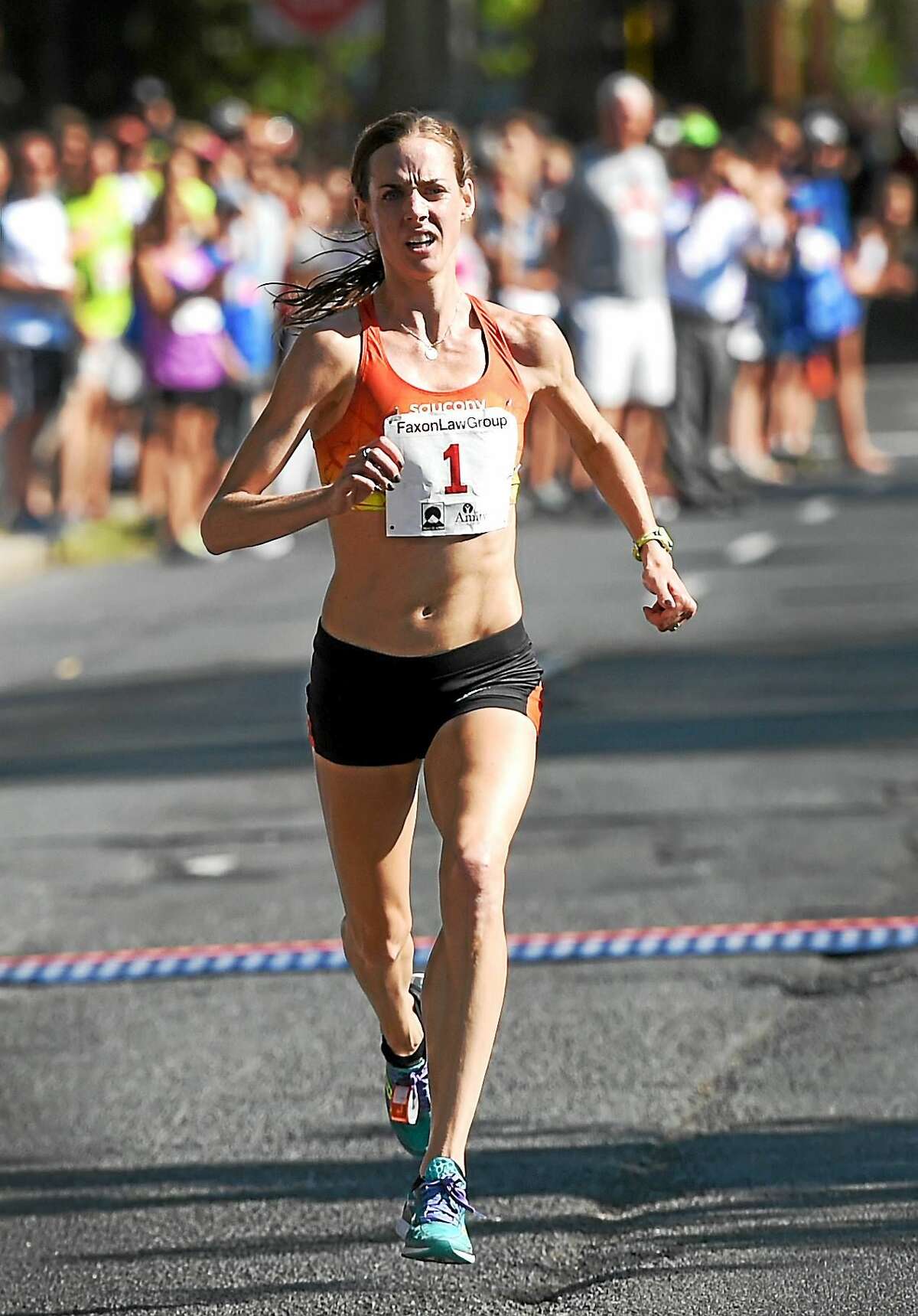 Molly Huddle runs toward the Temple Street finish line en route to winning the Faxon Law New Haven Road Race and 20K national championship on Monday.