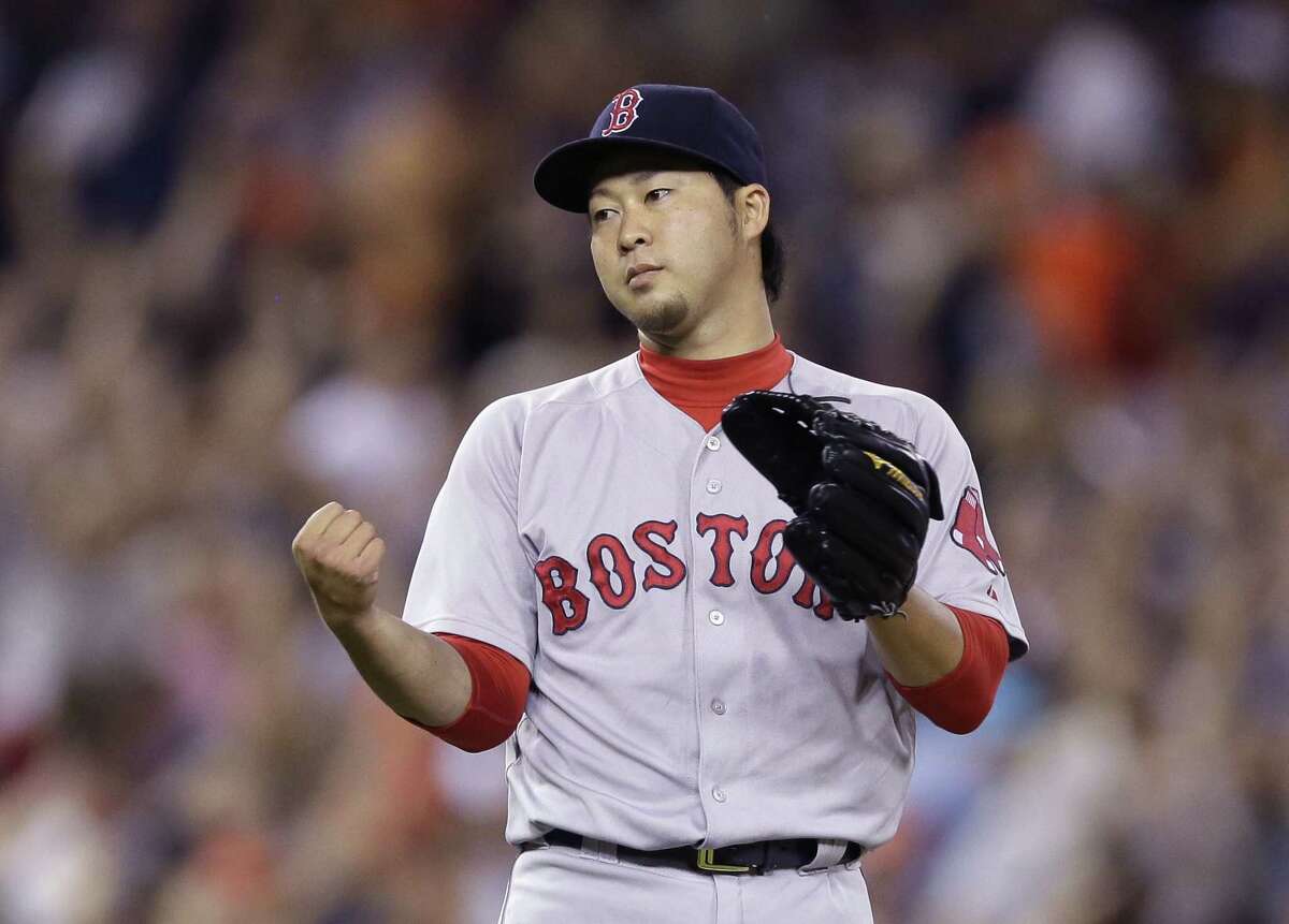 Red Sox relief pitcher Junichi Tazawa reacts after giving up a two-run home run to the Tigers’ Victor Martinez during the seventh inning on Saturday.