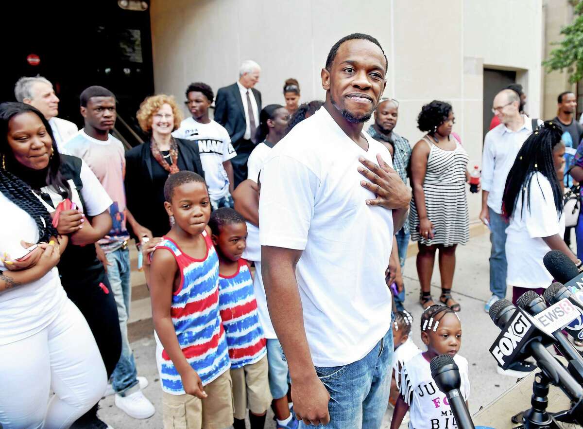 ARNOLD GOLD —NEW HAVEN REGISTER Bobby Johnson, center, surrounded by his family speaks to the press outside of Superior Court in New Haven on Friday after being released from prison.