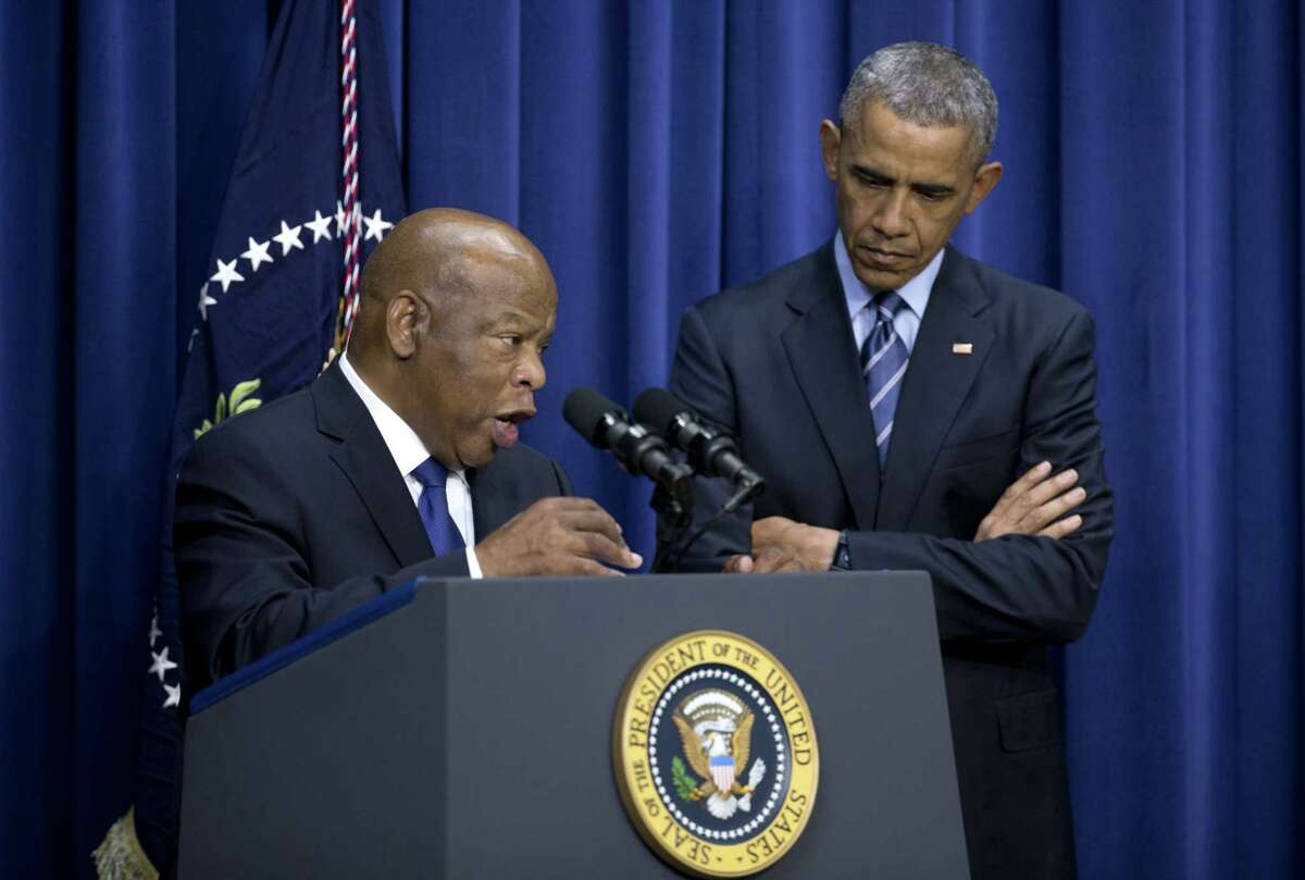 President Barack Obama stands by Rep. John Lewis, D-Ga., as he speaks in the South Court Auditorium in the Eisenhower Executive Office Building on the White House complex, Thursday, Aug. 6, 2015, in Washington, about the 50th anniversary of the Voting Rights Act.